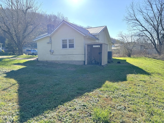 view of side of home with a lawn