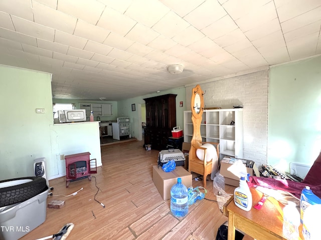 dining space featuring brick wall and hardwood / wood-style flooring