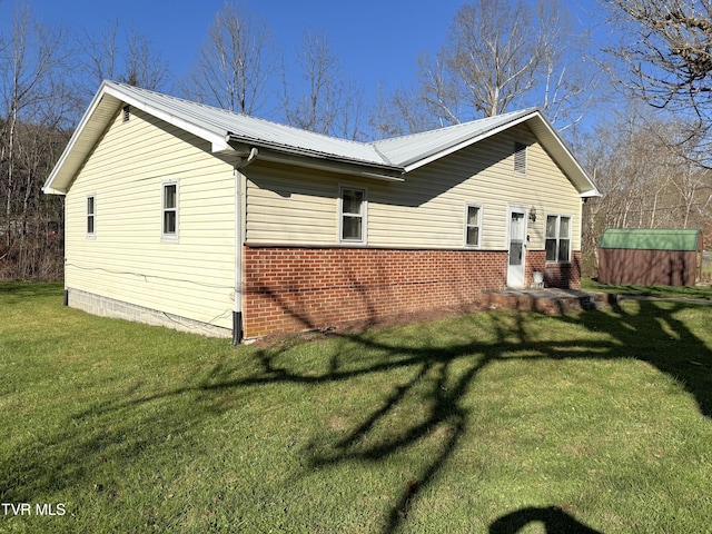 view of side of home with a yard