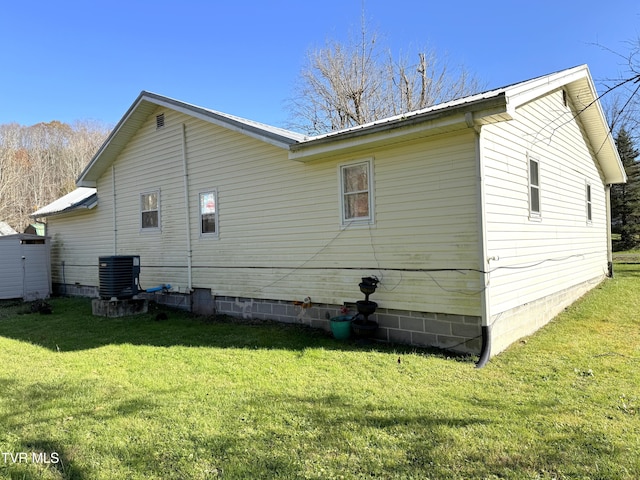 back of property featuring cooling unit and a yard