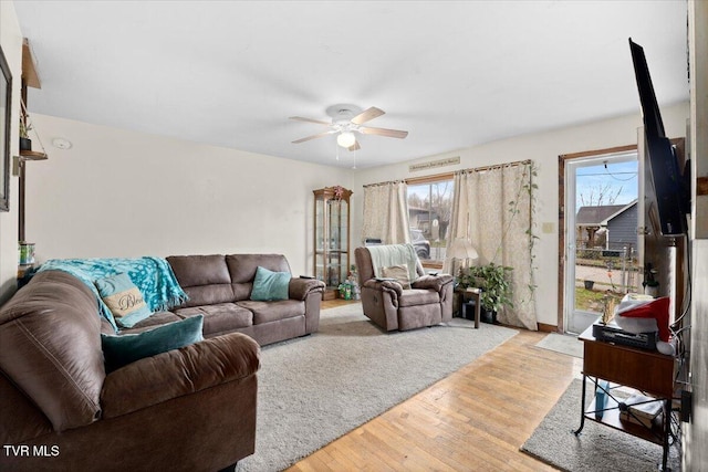 living room with hardwood / wood-style flooring and ceiling fan