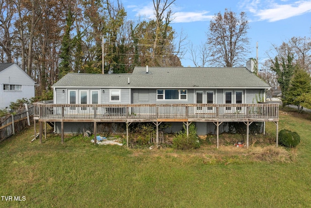 back of property with a yard and a wooden deck