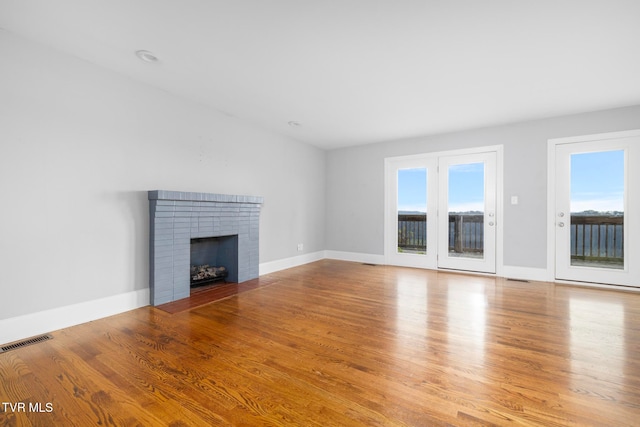 unfurnished living room with a fireplace and light hardwood / wood-style flooring