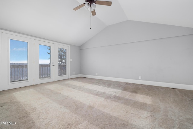 interior space with ceiling fan, lofted ceiling, and light carpet