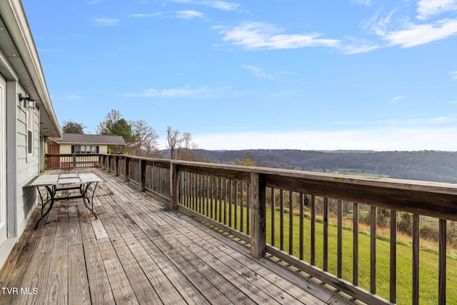 wooden deck with a lawn