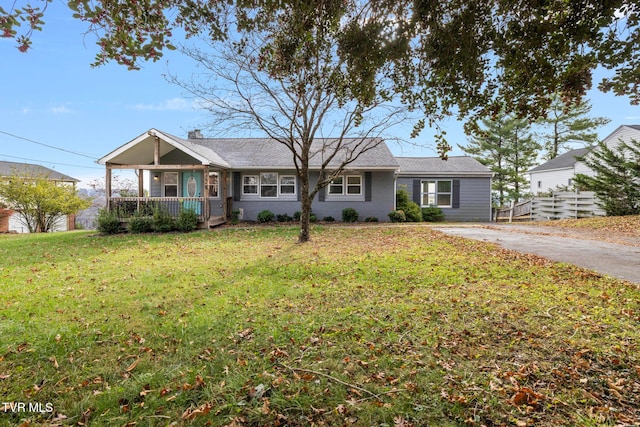 single story home featuring a porch and a front yard