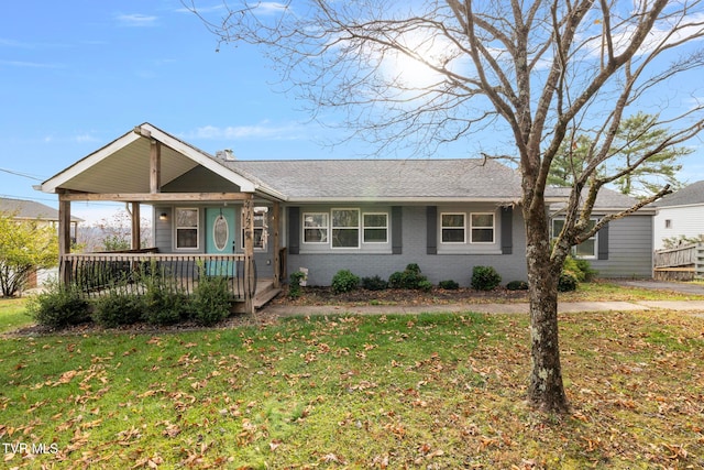 single story home with covered porch and a front lawn