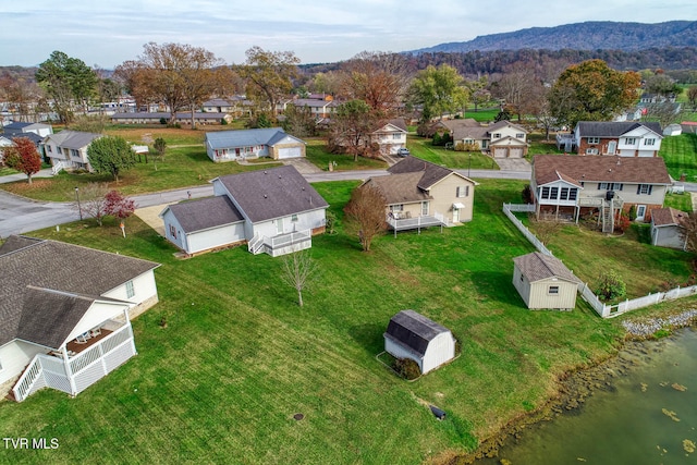 birds eye view of property featuring a water and mountain view