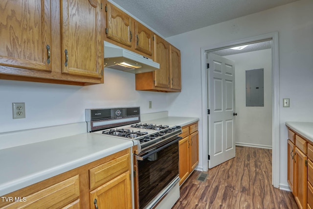 kitchen with dark hardwood / wood-style flooring, gas stove, electric panel, and a textured ceiling