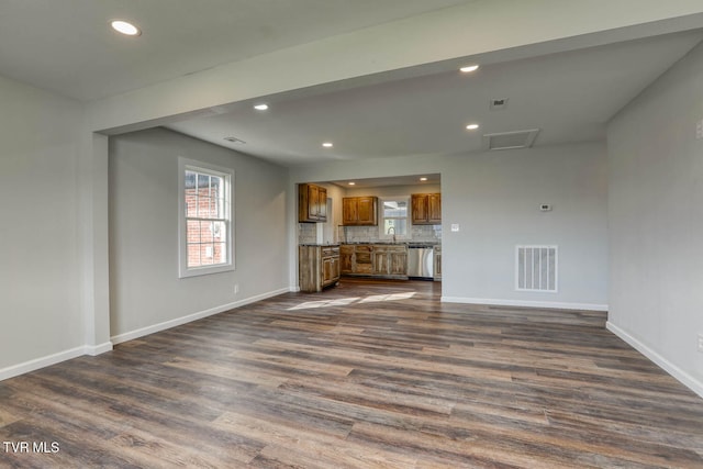 unfurnished living room featuring recessed lighting, visible vents, dark wood finished floors, and baseboards