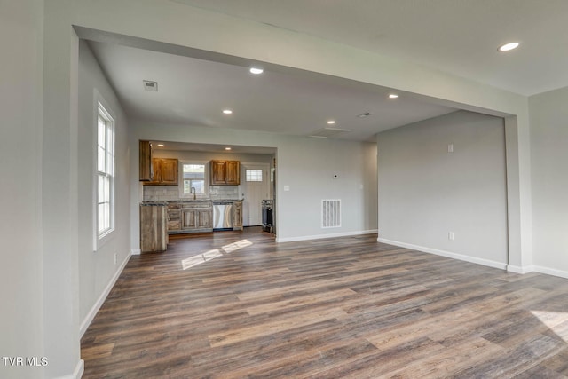 unfurnished living room with recessed lighting, dark wood-style flooring, visible vents, and baseboards