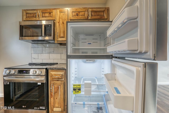 kitchen with stainless steel appliances, brown cabinetry, and backsplash