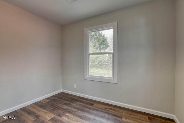 unfurnished room featuring dark wood finished floors and baseboards