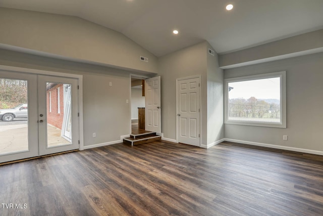 unfurnished room featuring visible vents, baseboards, dark wood-style floors, vaulted ceiling, and french doors