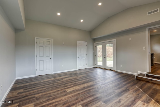 unfurnished room featuring lofted ceiling, dark wood-type flooring, visible vents, baseboards, and french doors