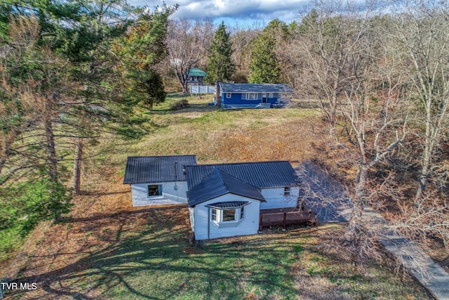 birds eye view of property with a wooded view