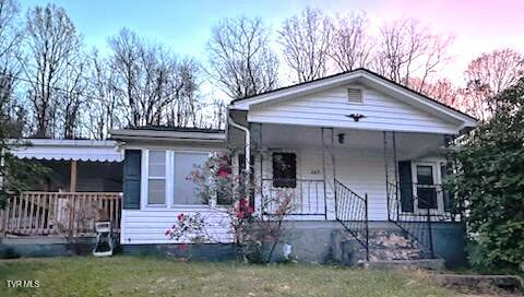 bungalow-style house with a lawn and a porch