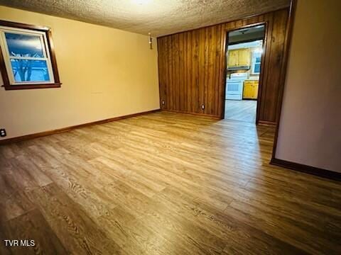 unfurnished room featuring hardwood / wood-style floors and a textured ceiling