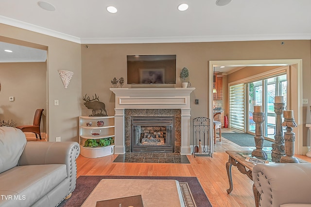 living room with a fireplace, wood-type flooring, and crown molding