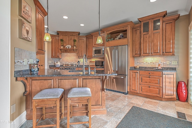 kitchen featuring built in appliances, sink, hanging light fixtures, and tasteful backsplash