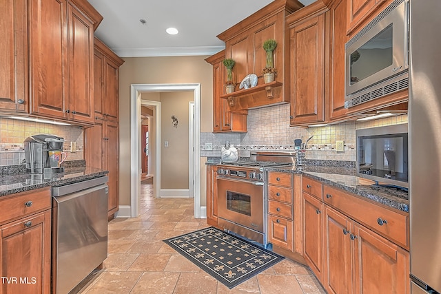 kitchen featuring decorative backsplash, dark stone countertops, ornamental molding, and appliances with stainless steel finishes