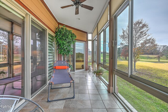 sunroom / solarium featuring ceiling fan