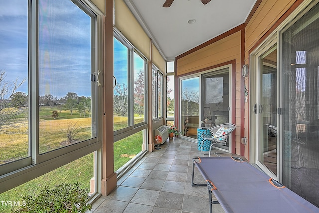 unfurnished sunroom featuring plenty of natural light, ceiling fan, and vaulted ceiling