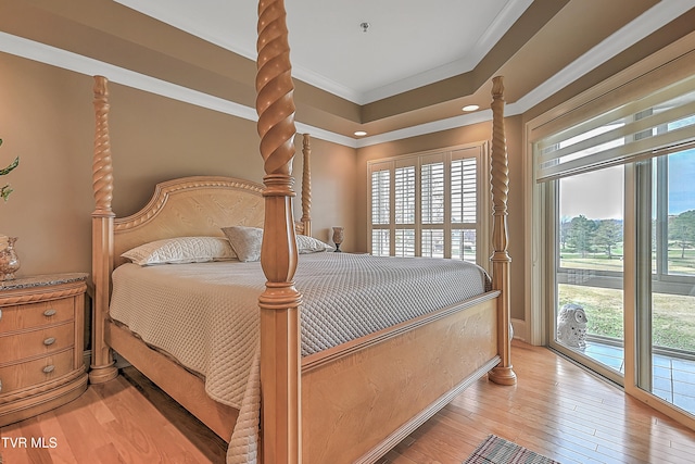 bedroom with access to outside, light hardwood / wood-style floors, and multiple windows