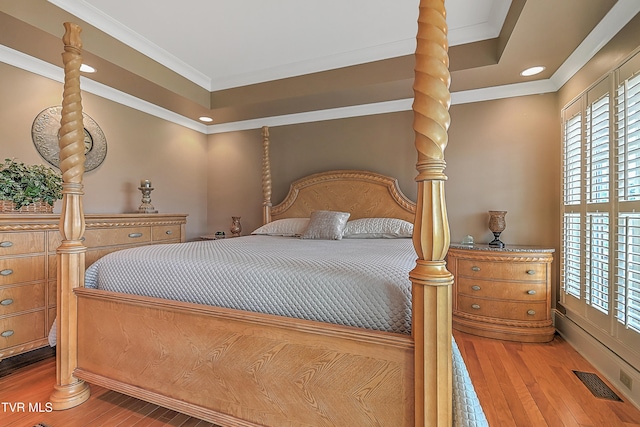 bedroom with wood-type flooring and ornamental molding