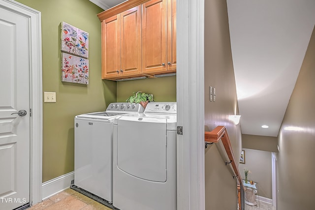 washroom featuring washer and dryer and cabinets