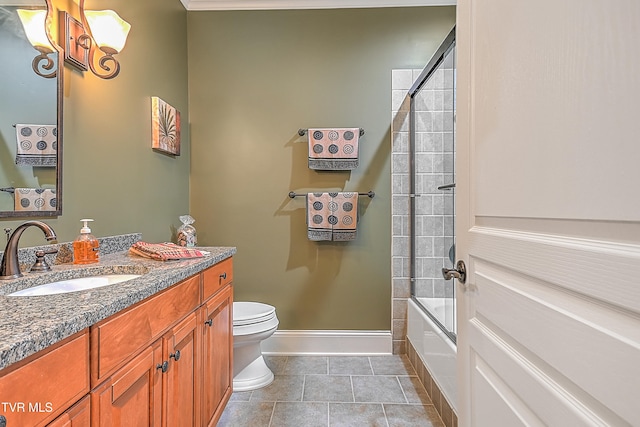 full bathroom featuring tile patterned flooring, vanity, toilet, and enclosed tub / shower combo