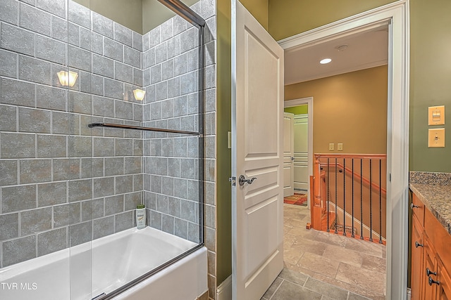 bathroom with shower / bath combination with glass door and vanity