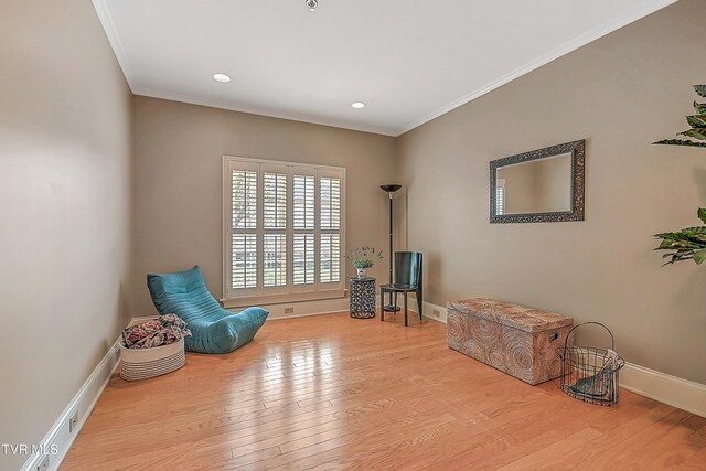 sitting room featuring light hardwood / wood-style floors and ornamental molding