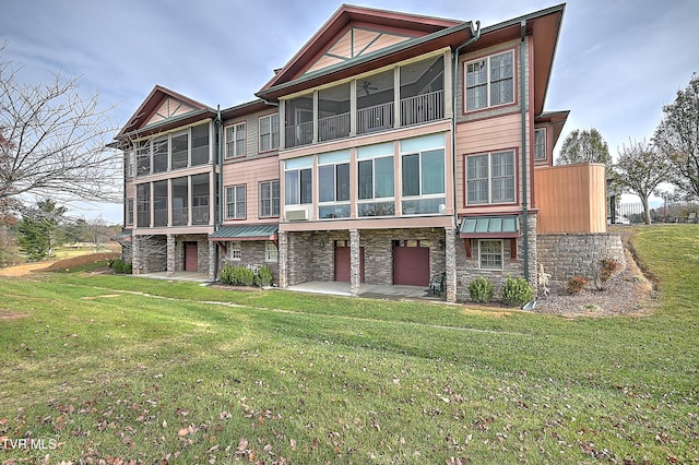 back of house with a lawn and a patio area