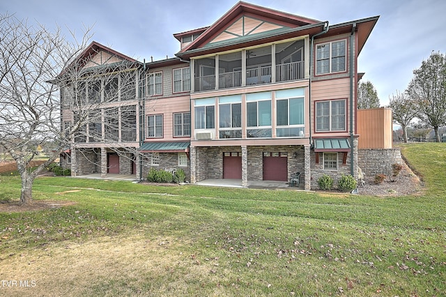 view of front of home with a front yard and a patio area