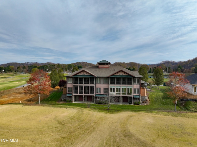 back of house featuring a sunroom