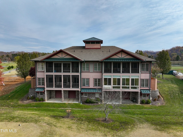 rear view of property with a yard and a patio