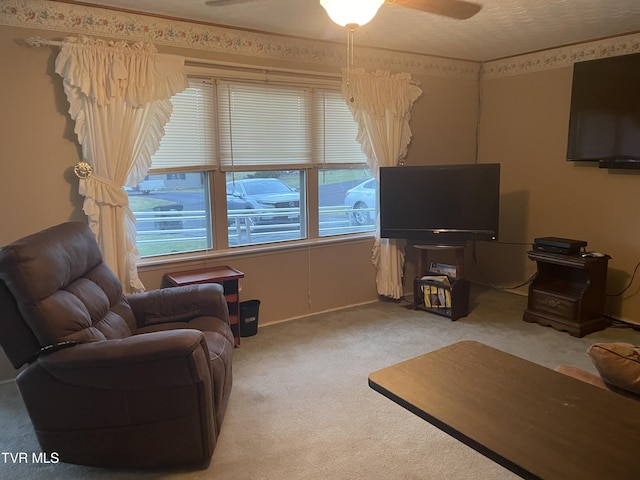 carpeted living room featuring ceiling fan