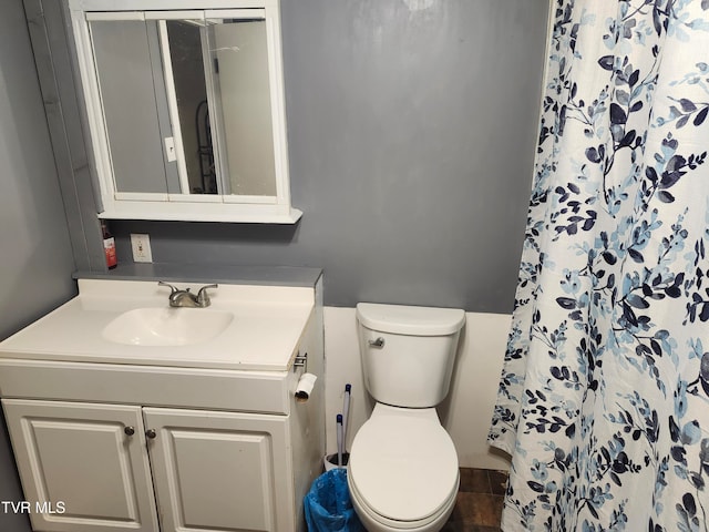 bathroom featuring a shower with curtain, vanity, toilet, and tile patterned flooring