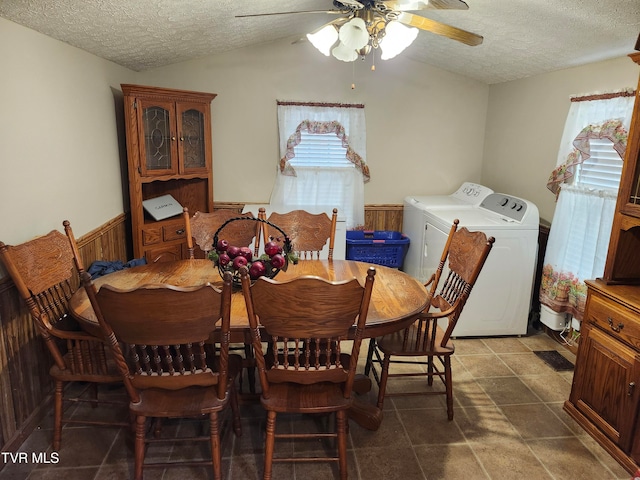 dining room with plenty of natural light, independent washer and dryer, a textured ceiling, and vaulted ceiling