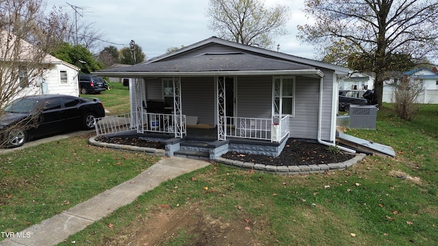 bungalow-style house featuring covered porch and a front lawn