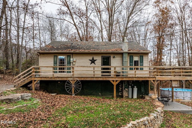 rear view of house featuring a swimming pool side deck and a patio