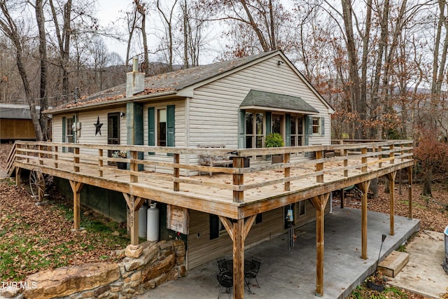 back of property with a patio and a wooden deck