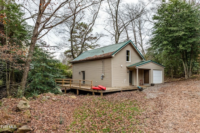 exterior space with a wooden deck and a garage