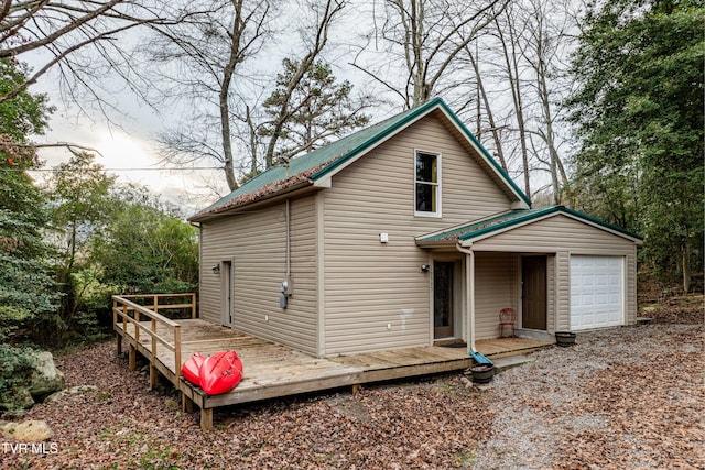 view of front of home featuring an outdoor structure, a deck, and a garage