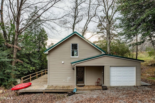 front of property featuring a wooden deck and a garage