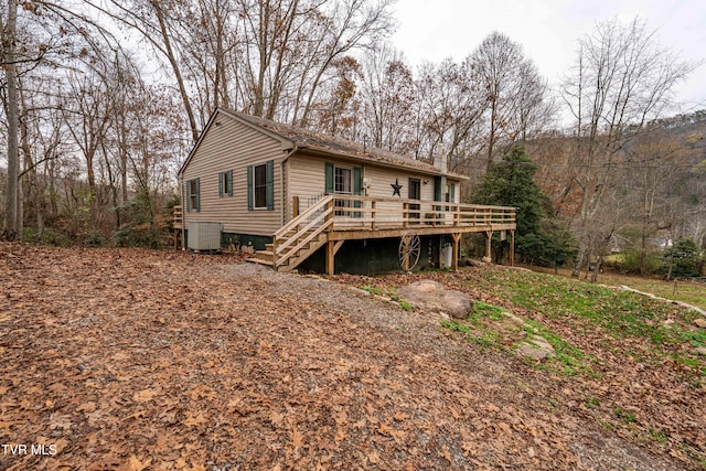 rear view of property featuring a wooden deck