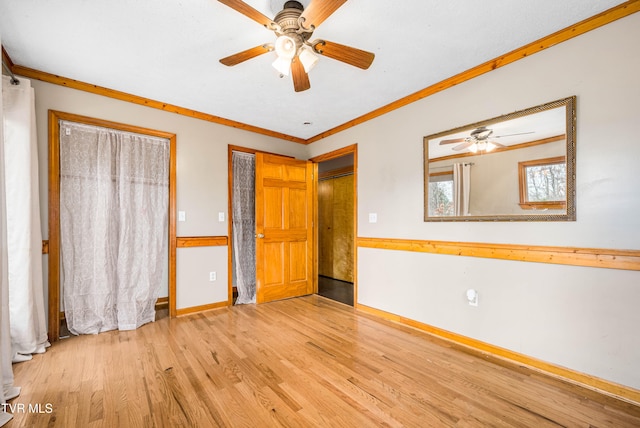 unfurnished bedroom with ceiling fan, ornamental molding, and light hardwood / wood-style flooring