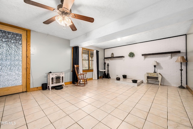 interior space featuring light tile patterned floors, a textured ceiling, and ceiling fan