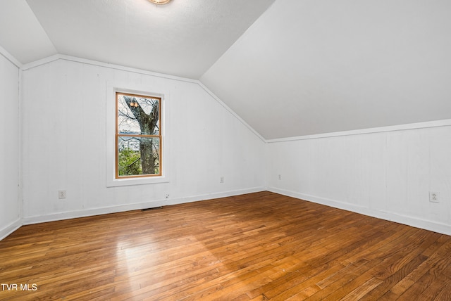 bonus room with lofted ceiling and wood-type flooring